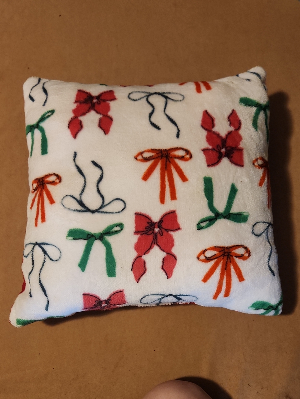 Plush Decorative Bow Print Throw Pillow - White with Red, Green & Orange Bows